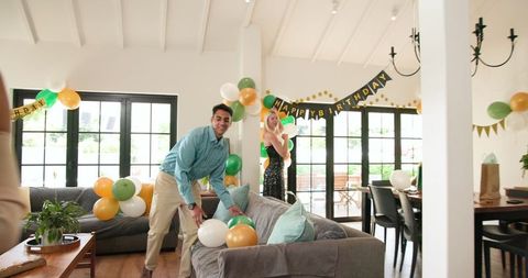 Friends Preparing Colorful Birthday Decorations Sunny Living Room