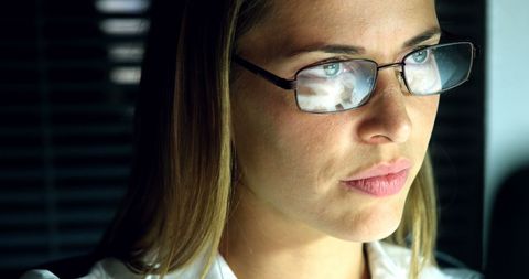 Focused Woman Analyzing Information on Computer
