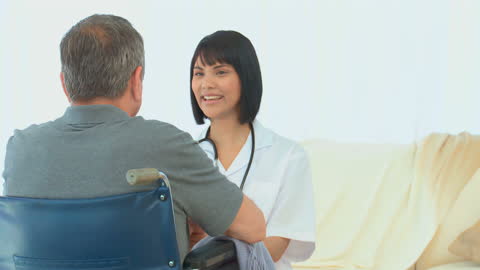Nurse Assisting Elderly Patient in Comfortable Home Environment
