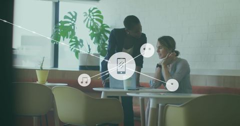 Diverse Female Coworkers Collaborating with Technology Overlay