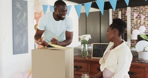 Happy Couple Celebrating Baby Shower with Blue Balloons