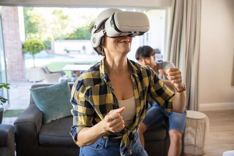 Joyful Couple Experiencing Virtual Reality Entertainment at Home