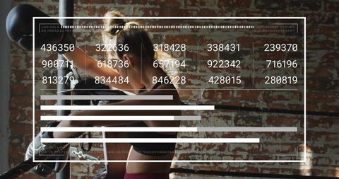 Female boxer training with hud data overlay in industrial gym boxing ring