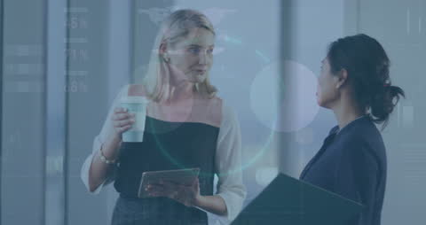 Businesswomen Discussing Data with Technology Overlay