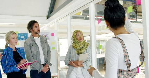 Creative Team Brainstorming with Colorful Notes in Modern Office