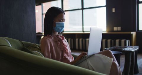 Woman Wearing Face Mask Using Laptop in Modern Office - Download Free Stock Images Pikwizard.com
