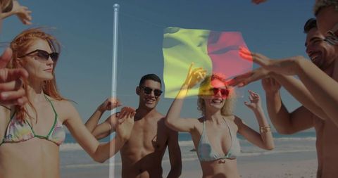 Joyful beach party with dancing friends and waving flag