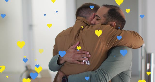 Two Men Embracing Amid Falling Blue and Yellow Hearts - Download Free Stock Photos Pikwizard.com