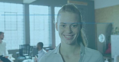 Professional Woman Smiling with Digital Data Interface Overlay in Office Environment