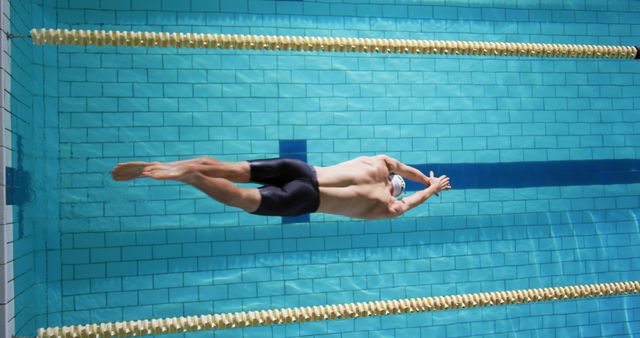 Male Swimmer Performing Stroke in Lap Pool - Download Free Stock Photos Pikwizard.com
