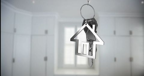 Key ring with house pendant in modern white hallway