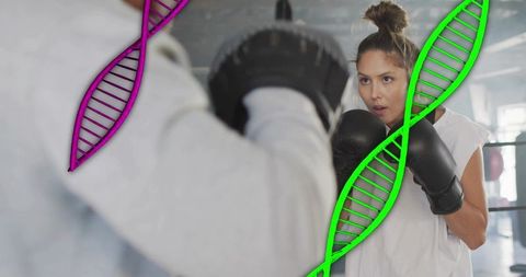 Female boxer training with coach mitts and neon dna overlay highlighting athletic genetics