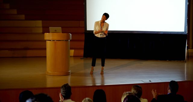 Motivational Speaker Engaging Audience on Stage in Conference Hall - Download Free Stock Images Pikwizard.com