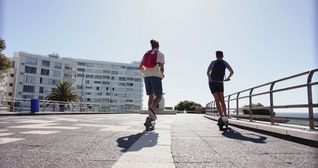 Two friends rollerblading on a sunny promenade by the sea - Download Free Stock Images Pikwizard.com