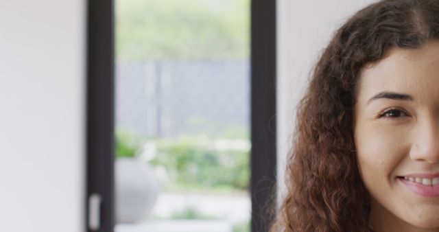 Close-up Portrait of Smiling Young Woman with Curly Hair - Download Free Stock Images Pikwizard.com