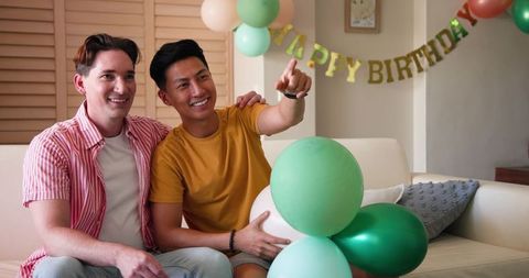 Gay Couple Celebrating Birthday with Balloons at Home