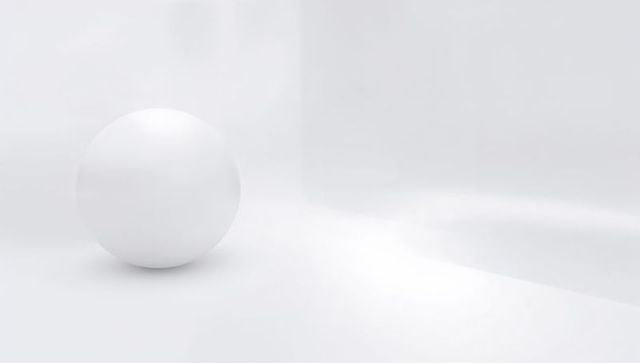 Resting white matte sphere in seamless white cyclorama with soft highlight and copy space