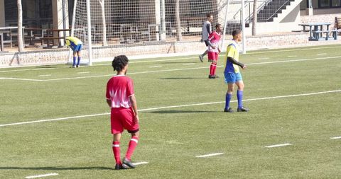 Youth soccer players competing on field in exciting match action