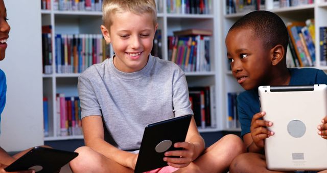 Happy Diverse Boys Using Tablets in School Library - Download Free Stock Images Pikwizard.com