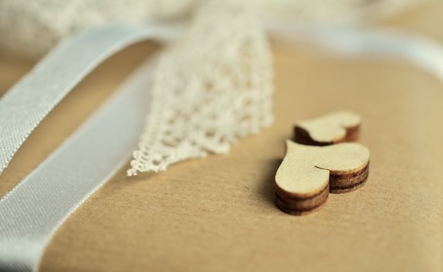 Rustic gift wrap featuring wooden heart ornament and lace ribbon perfect for weddings, anniversaries, or romantic gifts. Suitable for DIY craft projects, eco-friendly packaging, or special occasions with a handmade touch.