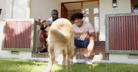 Friends relaxing on porch steps with golden retriever awaiting