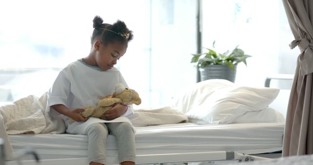 Little Girl in Hospital Bed Holding Stuffed Animal - Download Free Stock Images Pikwizard.com