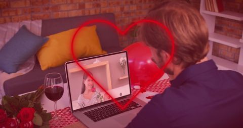Couple enjoys virtual date with laptop and romantic setup