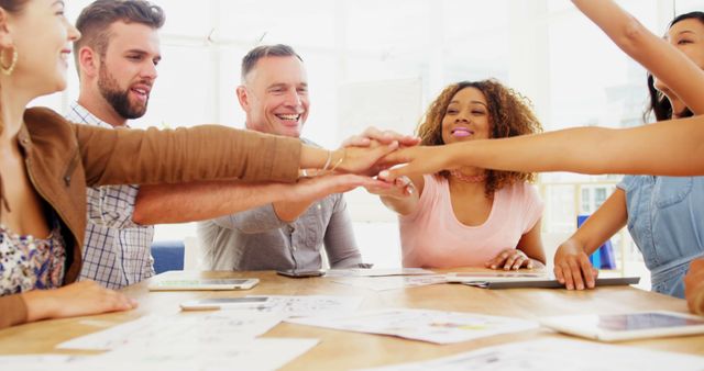 Diverse Team Celebrating Success with Group Handshake in Modern Office - Download Free Stock Images Pikwizard.com