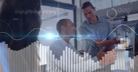 Business team collaborating and analyzing data dashboards during modern office meeting