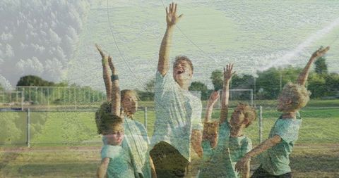 Cheering Youth Soccer Team and Coach Celebrating on Field