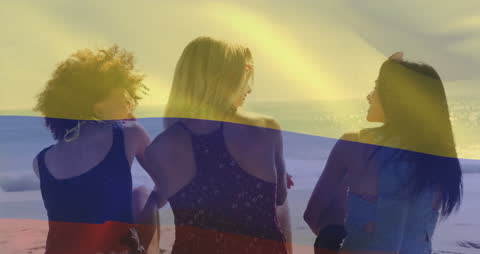 Women Relaxing on Beach with Colombian Flag Overlay