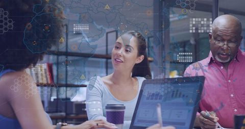 Diverse Business Team Analyzing Data With World Map Overlay