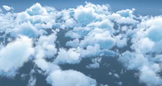 A serene view of fluffy white clouds against a soft blue sky, with copy space. This tranquil scene evokes a sense of calm and might be used for themes related to weather, nature, or travel.