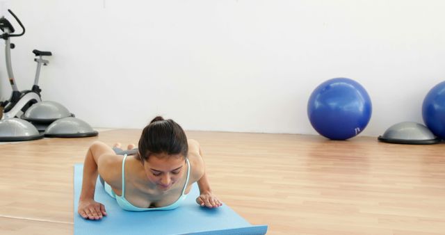 Young Woman Practicing Cobra Pose on Yoga Mat in Gym - Download Free Stock Images Pikwizard.com