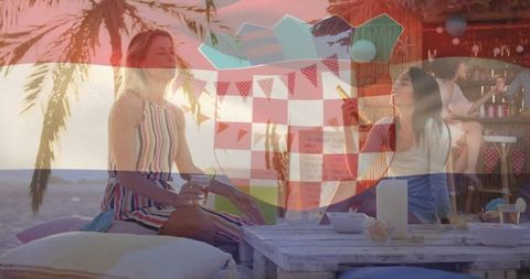Women socializing at beach lounge in tropical setting