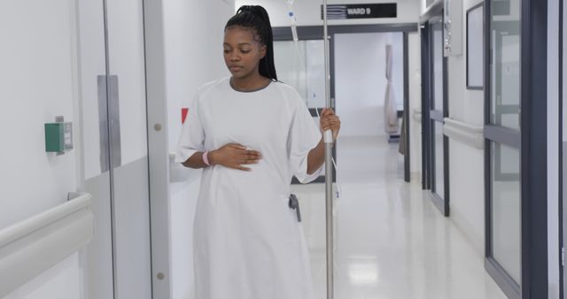 Pregnant Woman Walking in Hospital Corridor Holding IV Stand - Download Free Stock Images Pikwizard.com