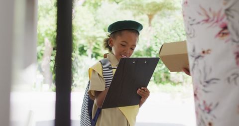 Young girl scout delivering package outdoors