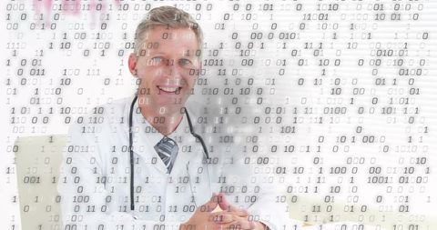 Smiling doctor leaning on desk with stethoscope and binary data overlay, digital healthcare