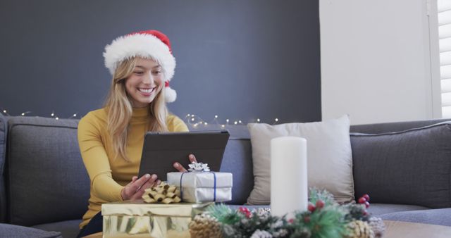 Woman in Santa Hat Video Calling on Tablet During Christmas Holiday - Download Free Stock Images Pikwizard.com