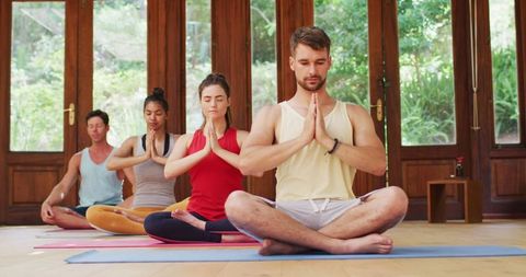 Diverse Group Meditating in Yoga Class at Studio Serenity