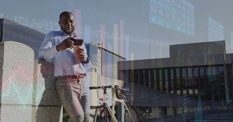Businessman using smartphone in city with bicycle for transportation