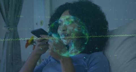 Woman using smartphone on couch with augmented reality holographic data overlay