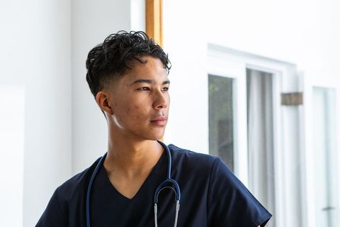 Confident Male Doctor in Modern Clinic Environment