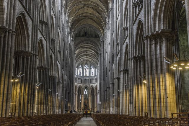 Providing glimpse of grand Gothic architecture, emphasizing tall arches, intricate columns and detailed craftsmanship in the historic cathedral interior. Useful for materials related to history, architecture, religion, European heritage, and tourism.