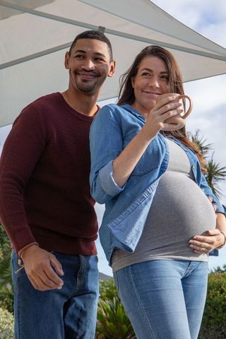 Happy Diverse Couple Enjoying Outdoor Moments Together with Mug