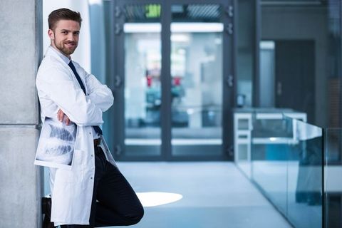 Confident Doctor Analyzing X-ray in Modern Hospital