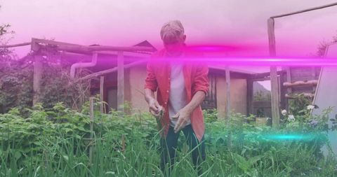 Gardener Tending Lush Backyard Garden Beneath Pergola