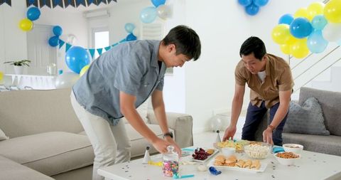 Friends Preparing for Birthday Party with Decorations