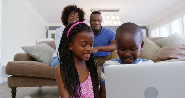 Happy African American Family Enjoying Technology Together at Home - Download Free Stock Images Pikwizard.com