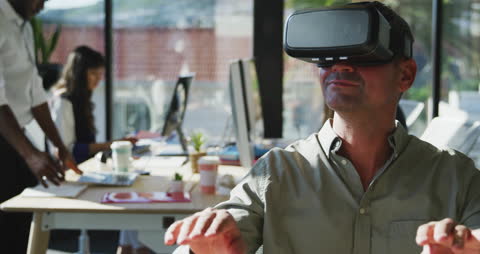 Man Using VR Headset in Modern Office for Virtual Interactions